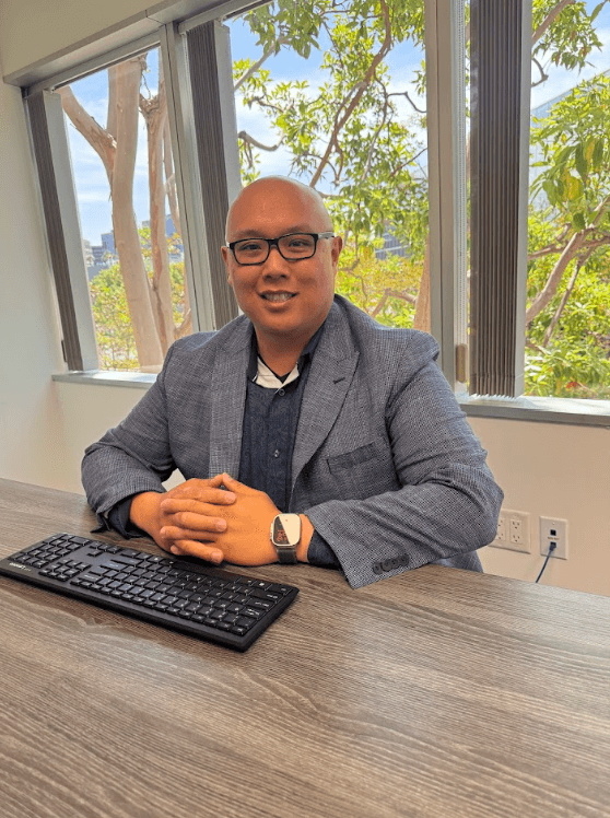 Gabriel Nguyen seated at his desk