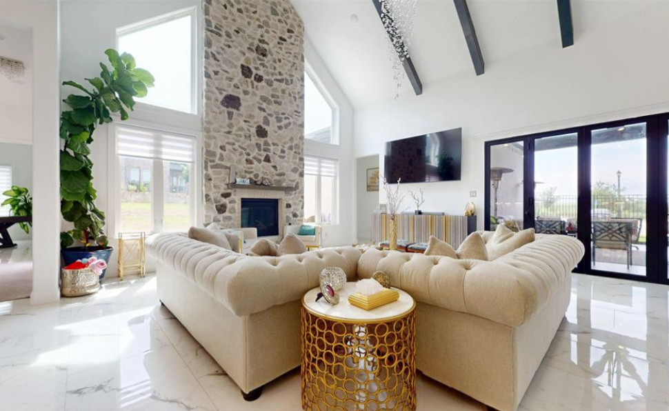 Luxury home interior with vaulted ceiling and stone fireplace
