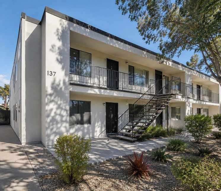 Modern multi-unit residential building with exterior stairway and balconies
